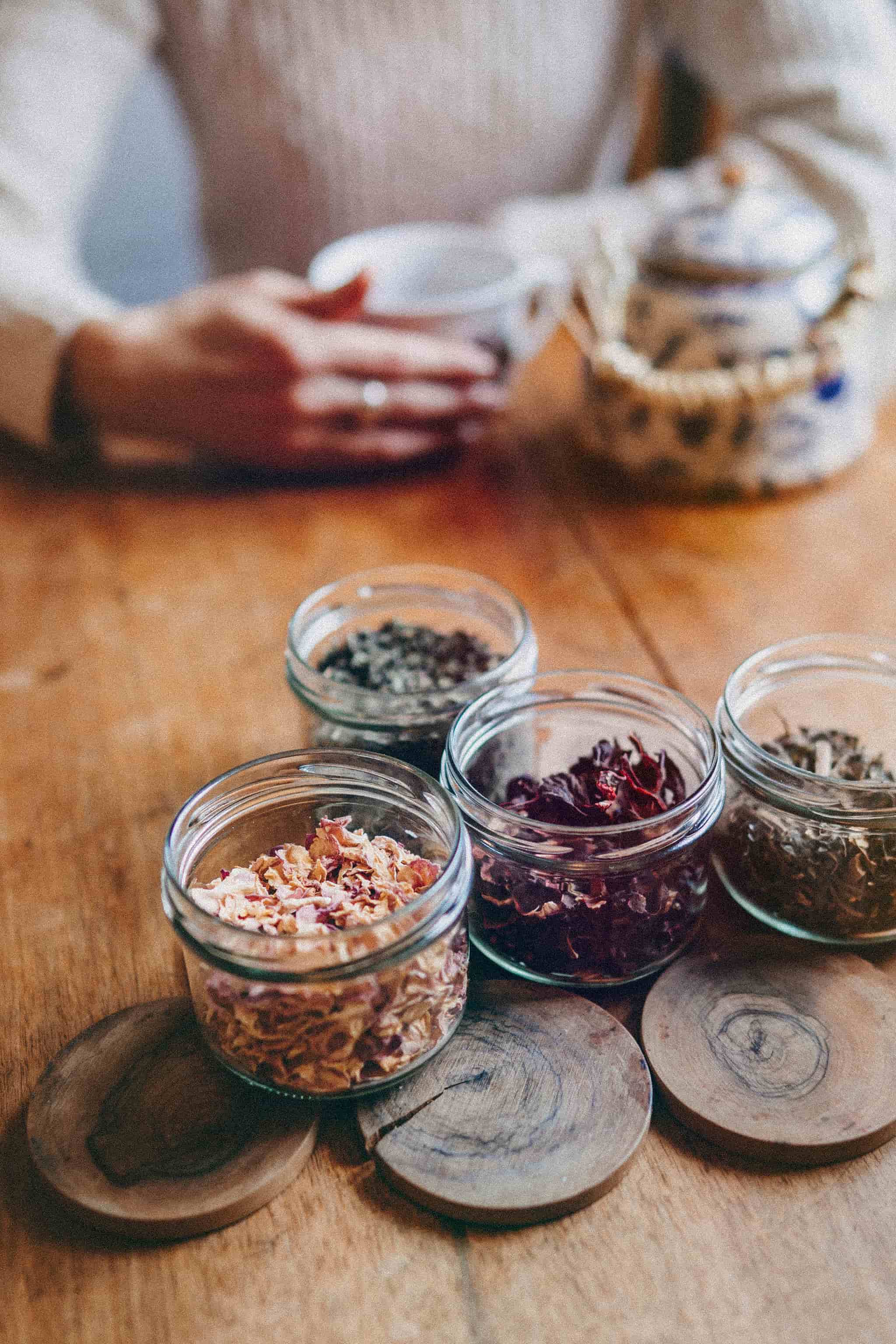 Herbs and a teapot arranged on a table