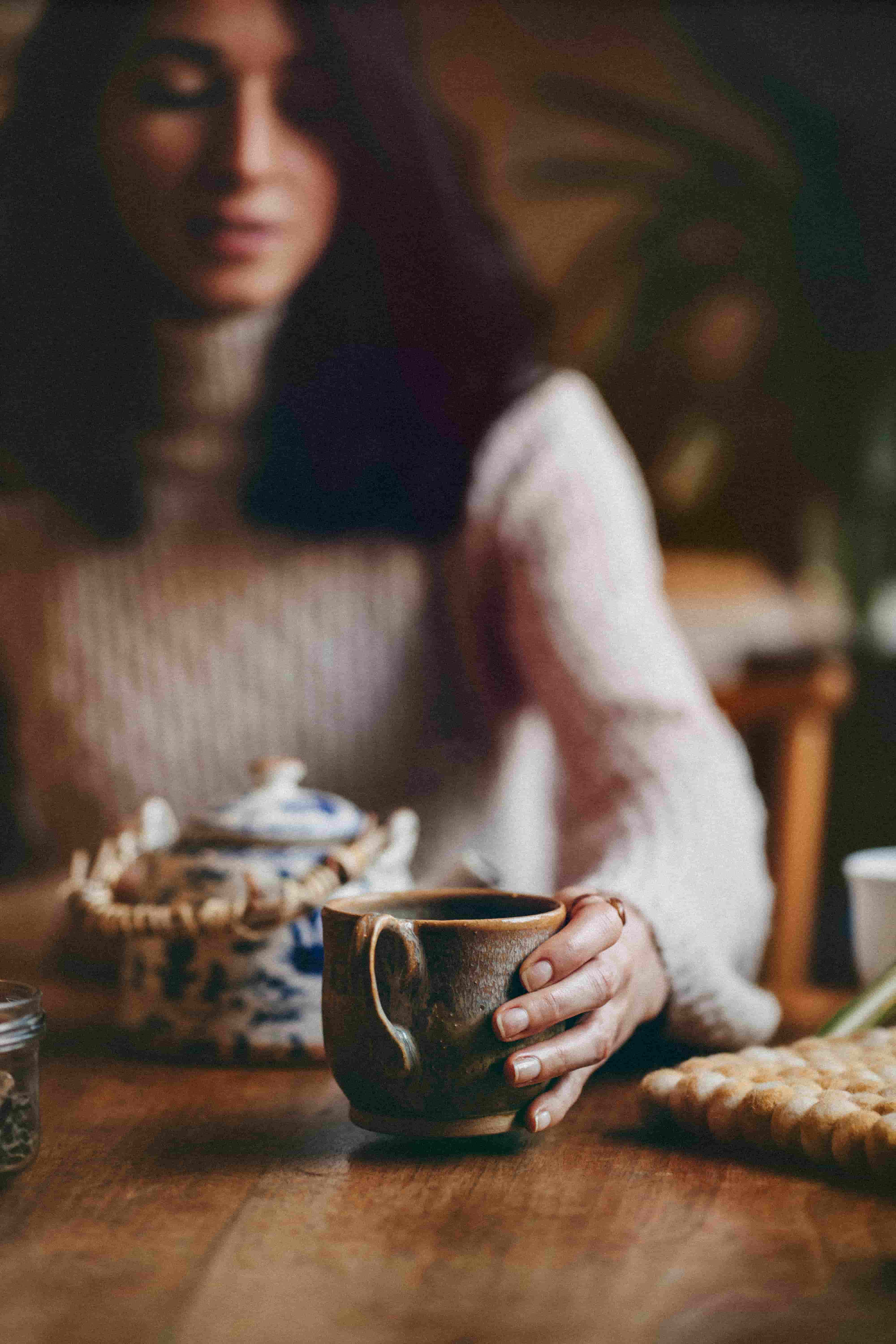 A woman at a table with a cup of tea